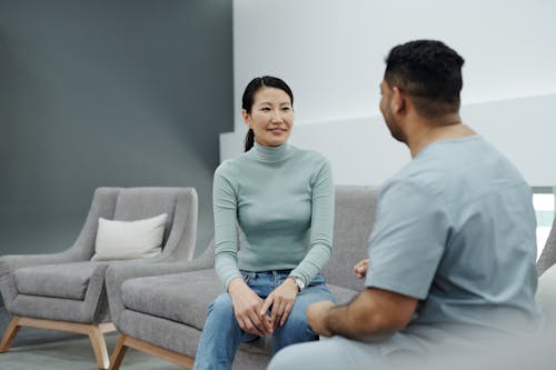A doctor and patient having a friendly conversation in a modern clinic.