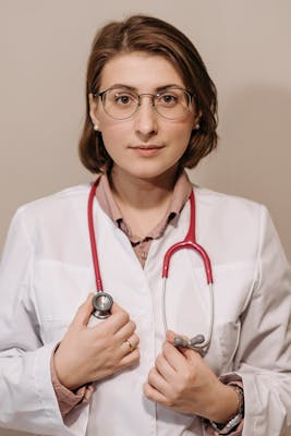 Portrait of a female doctor in a lab coat with a stethoscope, showcasing confidence and professionalism.