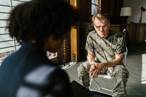 A soldier receiving counseling indoors, highlighting personal recovery.